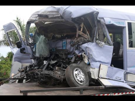 The ill-fated Toyota Coaster bus driven by James ‘Prento’ Davis that was involved in a three-vehicle collision on the Bustamante Highway in Clarendon on Monday. Davis and passenger Glenmore Pryce died.