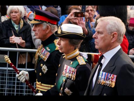 King Charles III, Princess Anne and Prince Andrew join the procession of Queen Elizabeth II’s coffin from the Palace of Holyroodhouse to St Giles’ Cathedral, in Edinburgh, Monday, September 12. King Charles arrived in Edinburgh to accompany his late mo