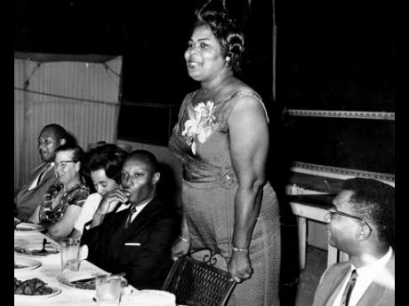 
Senator Esme Grant, parliamentary secretary in the Ministry of Education, speaking at the Annual Reunion dinner of the Ardenne High School Past Students’ Association on July 9, 1965, at the Cathay Club, Orange Street. From Left are: Ronald Douglas, Mary