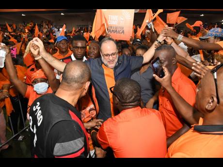 PNP President Mark Golding arrives to huge fanfare among party supporters at Sunday’s annual conference at the National Arena.