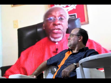 People’s National Party (PNP) President Mark Golding listens to a virtual address from former party leader and four-term prime minister P.J. Patterson during the PNP’s annual conference at the National Arena on Sunday.