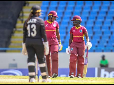 West Indies all-rounder Chinelle Henry (left) and Kyshona Knight have a mid-pitch conversation during the first One Day International between West Indies Women and New Zealand Women at North Sound in Antigua and Barbuda yesterday. 