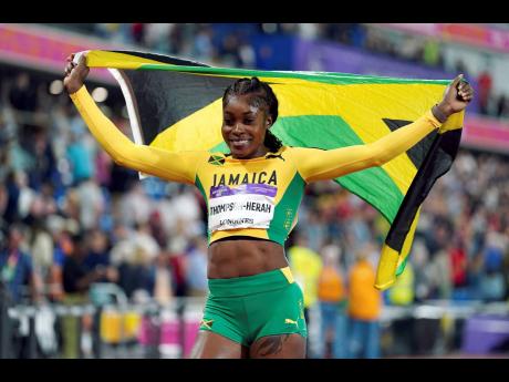 Jamaica’s Elaine Thompson Herah celebrates after winning the women’s 100m final in the Alexander Stadium at the Commonwealth Games in Birmingham, England, on Wednesday, August 3, 2022. 