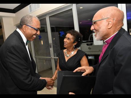 Reverend Dr Howard Gregory (right), Bishop of Jamaica and the Cayman Islands, and his wife Charmaine greet David Miller, president of the Calabar Old Boys’ Association.