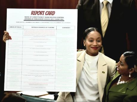 Rhoda Crawford, MP, Manchester Central, holds up a report card detailing her performance over the past two years after her presentation in Parliament on Tuesday, September 20. 