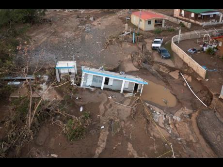 A house lays in the mud after it was washed away by Hurricane Fiona at Villa Esperanza in Salinas, Puerto Rico, on Wednesday, September 21. Fiona left hundreds of people stranded across the island after smashing roads and bridges, with authorities still st