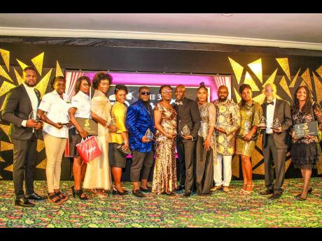 Sterling Awards organiser Basillia Barnaby-Cuff (fifth right) is flanked by the 2019 winners and legend honourees (from left) Robert Green from The Anointed Musicianz and Singers; two representatives from Image Jamaica; The Martin’s Heritage sisters; Jim