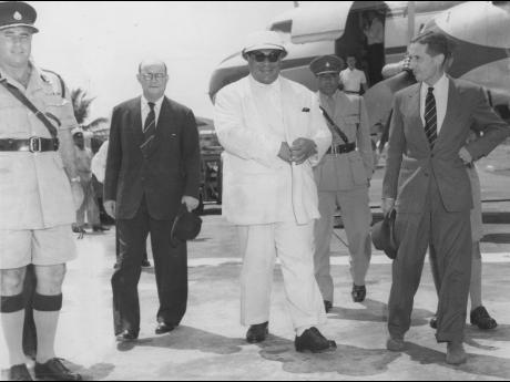 Prince Tungi, CBE, crown prince of Tonga in the South Pacific (second from left,) with Governor’s Deputy, John Stewart (right); Minister of Finance Noel Nethersole. Behind them is Major David Smith, AD to the governor.