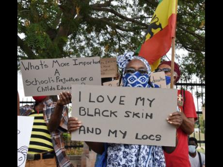 Rastafarians demonstrate in front of the Ministry of Education headquarters at National Heroes Circle, Kingston, to protest discrimination against the wearing of locked hair in schools. The protest was sparked by the July 31 Supreme Court ruling involving 
