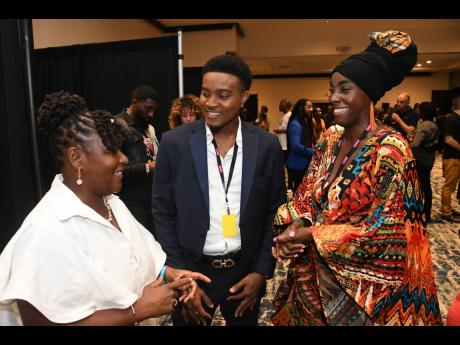 The Caribbean Export Development Agency Services Specialist Allyson Francis (left) enjoys a lively conversation with Caribbean Rhythm Showcase artiste Jay-R, from St Vincent and the Grenadines (centre) and UK talent scout Bashiyra. 