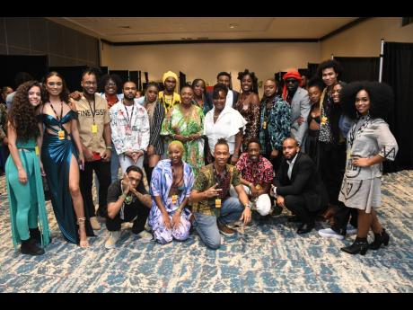 
Minister of Culture, Gender, Entertainment and Sport Olivia Grange (centre) shares a moment with Allyson Francis, Marvin Baptiste and the 20 Caribbean Rhythm Showcase artistes after the event last Sunday at The Jamaica Pegasus hotel. 