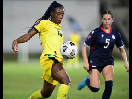 Jamaica’s Tiffany Cameron (left) in action against the Dominican Republic’s Nadia Colon during a Concacaf Women's  World Cup Qualifier at Sabina Park, Kingston, on Tuesday, April 12, 2022. 