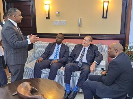 From left: Mark Hannah, founder of technology development company Rydeum Caribbean, Simon Lawrence, president of  Jamaica Union of Travellers Association (JUTA), Transport and Mining Minister Audley Shaw, and Everes Coke, councillor for the Maroon Town Div