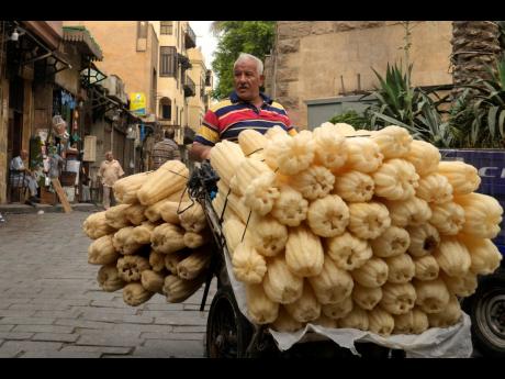 A luffa vendor looks for customers in the Old Cairo district of Cairo, Egypt. 