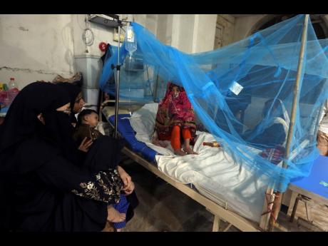 A patient suffering from dengue fever, a mosquito-borne disease, is treated in an isolation ward, at a hospital in Karachi, Pakistan. 