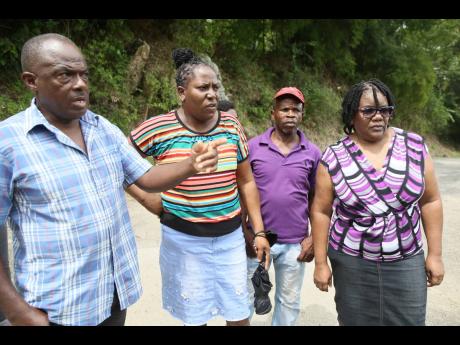 Residents of Mina, (from left) Errol Newell, Doreen Morris, Paul Marshall, and Lorna Nevers, share that the breakaway along the Sanguinetti to Coffee Piece main road in Clarendon poses great inconvenience for commuters. 