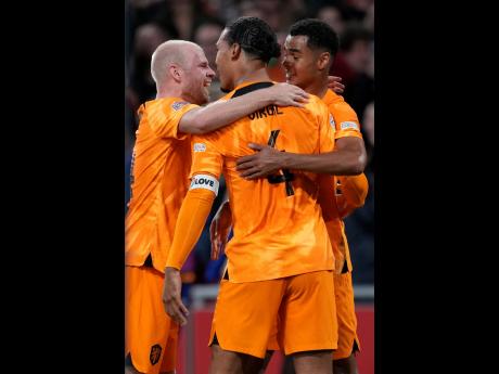 Netherlands’ Virgil van Dijk (centre) celebrates with teammates after scoring his side’s winning goal against  Belgium at the Johan Cruyff Arena in Amsterdam, Netherlands yesterday.
