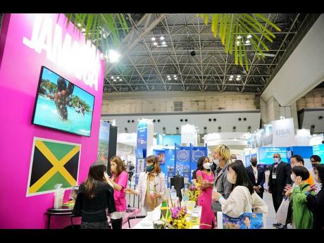 Patrons take an interest in Jamaica’s booth at Japan Expo in Tokyo.