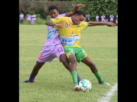 Irwin High’s Abraham Quest (left) and Green Pond High’s Trayvon Haughton battle for the ball during an ISSA/Digicel daCosta Cup football match at the Irwin High Sports Complex on Tuesday, September 20. Irwin High won 2-0.