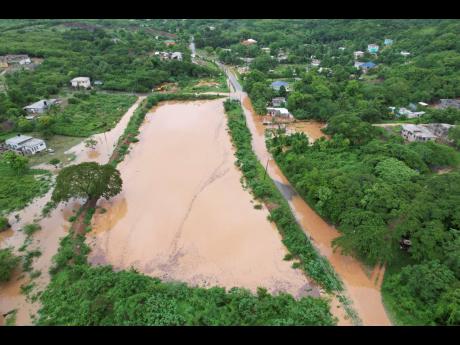 An aerial view Monday of Big Pond in Bannister, St Catherine, which is perennially flooded. 