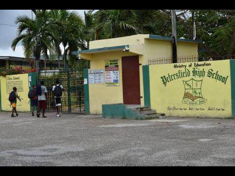 Students enter gates of the Petersfield High School in Westmoreland. 