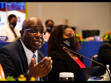 RJRGLEANER Communications Group CEO Gary Allen addressing the company’s annual general meeting at The Jamaica Pegasus hotel in New Kingston on Wednesday. To his left is Andrea Messam, group chief financial officer.