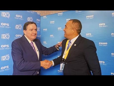Jamaica’s Minister of Health Dr Christopher Tufton congratulates Dr Jarbas Barbosa da Silva Jr after the latter was elected the new director general of the Pan American Health Organization Wednesday. The occasion was the 29th Pan American Sanitary Confer
