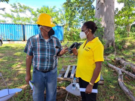 Ahmed Williams (left), Safety Officer at the Pan Caribbean Sugar Factory in Frome, Westmoreland, discusses healthcare needs and safety requirements with Marjorie Sharpe, Health Promotion and Education Officer at the Westmoreland Health Department, during a