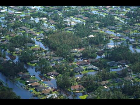 Homes inundated by floodwaters caused by Hurricane Ian in Fort Myers, Florida, as seen on Thursday.