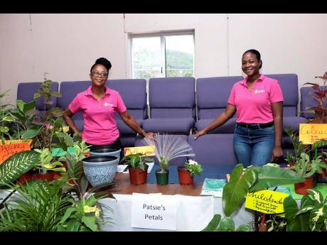 Patsie Rose (left) and one of her daughters, Taneisha, presenting an array of beautiful plants at the Just Grow Up Summit at the Emmanuel Apostolic Church in Portmore, St Catherine.