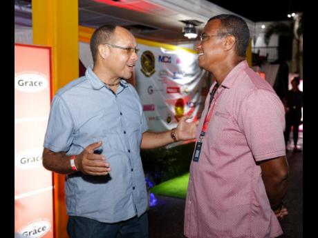 Jason Craig Watson (left), former captain of the Campion Manning Cup Team catches up with Andre Gray, former Wolmer’s Manning Cup Player and president of the Age Quod Agis Sports Alumni Association at N’Dulge, the annual reunion after party at C&C Sout