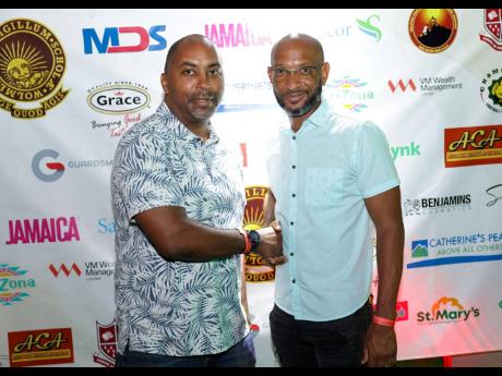 Julian Robinson (left), Campionite and member of parliament for South East St Andrew is greeted by Lissant Mitchell, former goalkeeper of the Wolmer’s Manning Cup Team and Age Quod Agis SAA executive member at N’Dulge, the annual reunion after party at