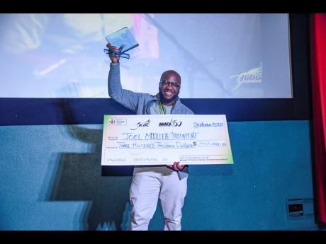 George Malcolm Walker, cinematographer and editor of ‘Hairport’, winner of the 2022 JCDC FIWI Short Film Competition, celebrates his team’s win at the award ceremony held at the Palace Cineplex on Thursday. 