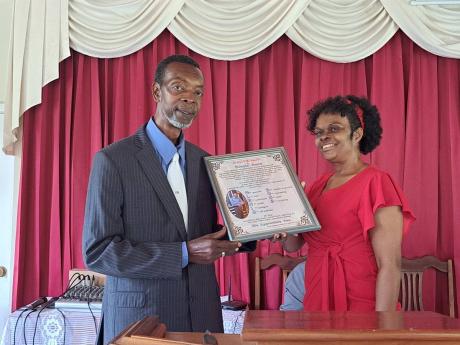 
Glenis Rose (left), a justice of the peace based in Blytheston, St James, and a retired information officer who worked at the Jamaica Information Service’s Montego Bay office, receives a citation from Sherna Bennett-Warner, assistant treasurer at the Ch