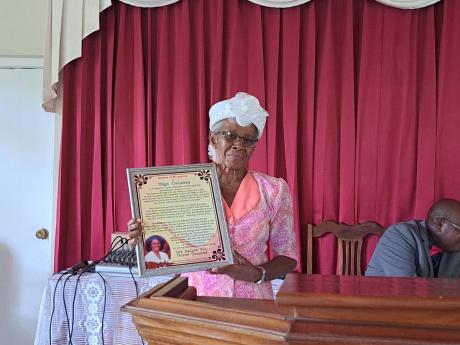 Olga Coulsley, a midwife from Chatham, St James, showcases her citation which she received during the Chatham Seventh-day Adventist Church’s Community Guest Day celebration on Saturday, September 24, 2022.