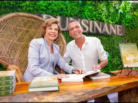 Diana Stewart (left) and Peter Melhado, president and CEO of the ICD Group and chairman of Sagicor Investments took a quick break for a photo op during Stewart’s autographing of Melhado’s recently purchased copy of her first book, Dunsinane: A Memoir.