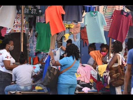 In this December 2021 photo shoppers are seen checking out clothes at Orange Street, downtown Kingston.