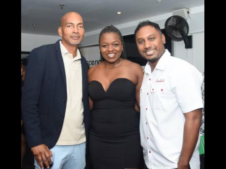 Jamaica Public Service’s Simoneese Williams is sandwiched by Conrod Allen (left), owner, Cover Me Up Tent, and Sandals Resorts International’s Crissano Dalley.