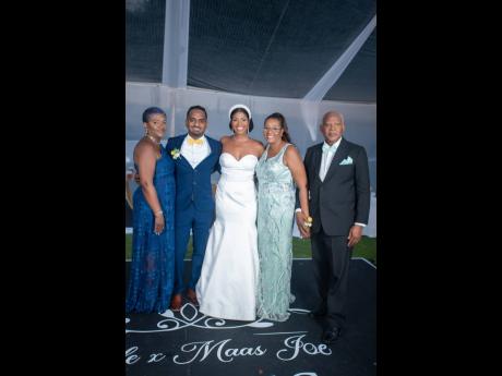 The lovely couple are joined by their parent. From left: Nadine Perry, mother of the groom; the bride and groom, Lyndon and Rachael; Heatherdawn Blake-Brown, mother of the bride, and Denninston Brown, father of the bride.