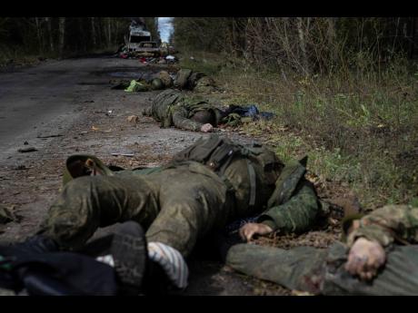 Dead bodies of Russian servicemen lie on the ground in recently recaptured town of Lyman, Ukraine, on Monday.