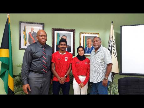 G.C. Foster College principal Maurice Wilson (left) and Chairman Vishu Tolan (right) welcome Ibadulla Adam and Himna Hassan from the Maldives to the institution on Monday. 
