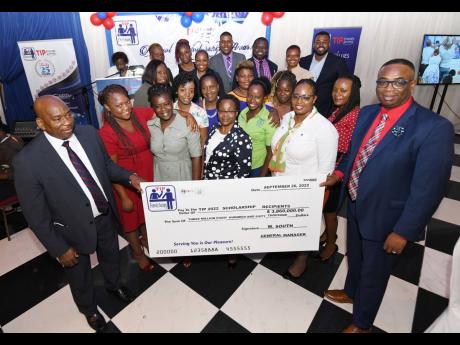  To mark its silver anniversary, TIP Friendly Society has contributed $3.86 million in scholarships to 54 students for the current school term. Wilton South (front left), general manager, TIP Friendly Society, and Dr Garth Anderson (front right), president