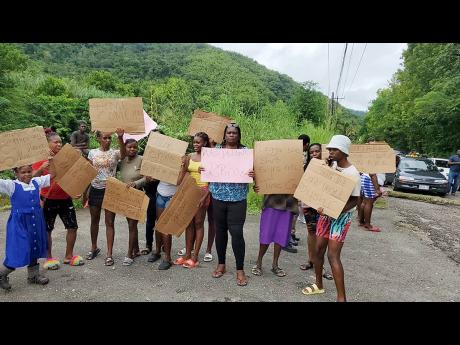 Residents of Frankfield in Clarendon stage a protest for a new bridge to be installed for the benefit of surrounding communities.