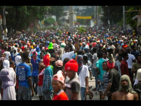Demonstrators fill the streets during a protest to demand the resignation of Prime Minister Ariel Henry, in the Petion-Ville area of Port-au-Prince, Haiti, on Monday, October 3.