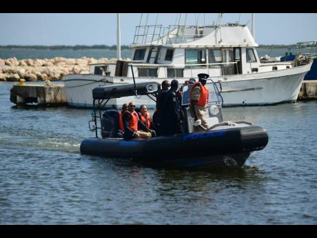 The newly donated vessel returns to dock at the Marine Police headquarters, moments after it was handed over to the Jamaica Constabulary Force by Japanese Ambassador Masaya Fujiwara (not pictured) at Newport East in Kingston on Wednesday. Among those on bo