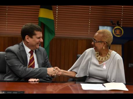 Cuban Ambassador Fermîn Gabriel Quiñones Sanchéz (left) exchanges pleasantries with Jamaica’s minister of education, Fayval Williams, during a courtesy call at her Heroes Circle, downtown Kingston-based offices on Wednesday.