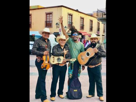 Jamaican musician Kenardo Ellis stands with a Mariachi band in Querétaro, Mexico.