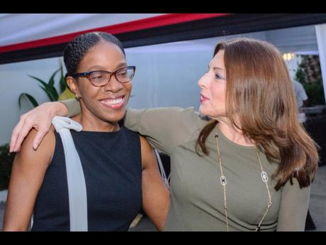 Amanda Fraser (left), first secretary, Trinidad and Tobago High Commission, is embraced by Gina Guillén Grillo, ambassador of Costa Rica, at the reception celebrating Trinidad and Tobago’s 60th anniversary of independence and 46th Republic Day.