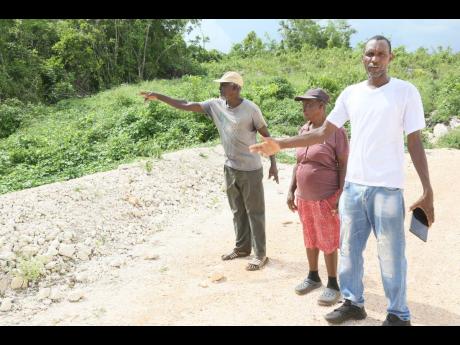 From left: Phillip McLean, Bernid Bartley and Christopher Thomas, who live in St Toolies, Manchester, lament the poor state of the roads in the community. The residents say water run-off from the under-construction toll highway linking May Pen and Mandevil