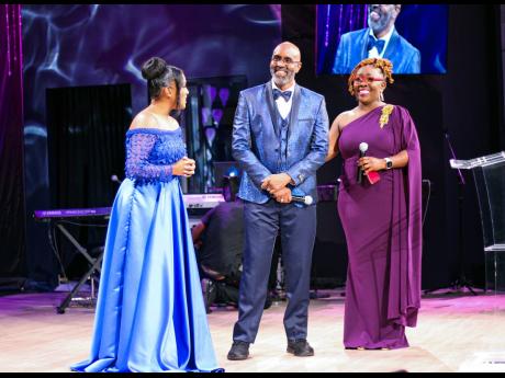Long-time gospel supporter and Love 101 FM broadcaster, Nigel Wilkinson, is flanked by Sterling Gospel Music Awards founder Basillia Barnaby-Cuff (left) and co-host Nadine Blair as he is presented with the Sterling Award for Excellence.